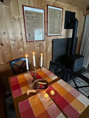 a table with two candles on top of it at Cozy Off-Grid Cabin - No Power, No Running Water