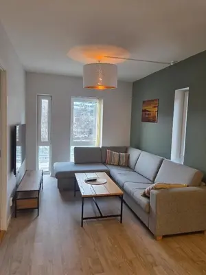 a living room with a couch and a table at Central 2-Bedroom Apartment in Voss in Vossevangen