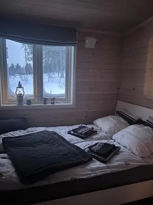 a large bed in a room with a window at Hytte Hummelfjell, Os in Os