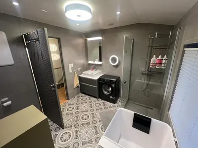 a bathroom with a shower and a sink and a toilet at Modern, spacious top apartment in Lii
