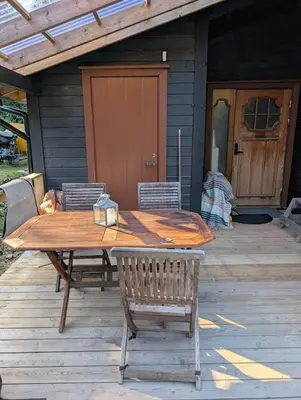 a wooden table and chairs on a patio at Rasteplassen