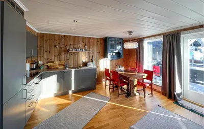 a kitchen with a table and a dining room at Gorgeous Home In Sjusjøen With Wifi in Sjusjøen