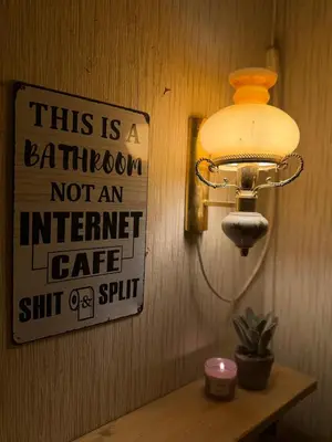 a sign on a wall with a light on a table at Musekroken in Elverum