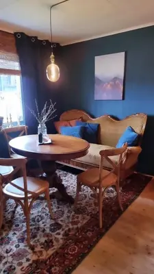 a living room with a table and a couch at Llama Lodge 8 beds 4 Bedrooms in Kleivane