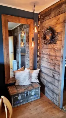 a room with a mirror and a wooden wall at Llama Lodge 8 beds 4 Bedrooms in Kleivane