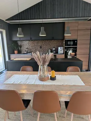 a kitchen with a large wooden table and chairs at Modern cabin with jacuzzi near Trysil alpine in Trysil