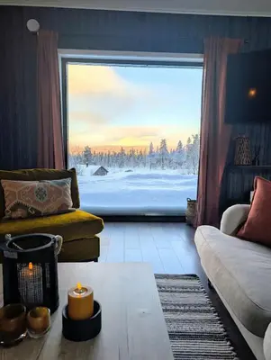 a living room with a couch and a large window at Modern cabin with jacuzzi near Trysil alpine in Trysil