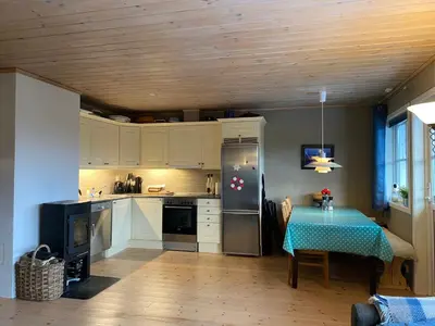 a kitchen with a table with a blue table cloth at Leilighet i Fageråsen, Trysil, med ski inn og ut in Trysil