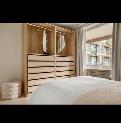 a bedroom with a dresser and a bed with a window at New modern apartment, close to airport in Bergen