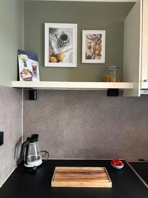 a kitchen with a counter top with a shelf at Corner apartment with balcony in Bergen in Bergen