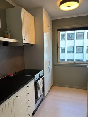 a kitchen with a black counter top and a window at Corner apartment with balcony in Bergen in Bergen