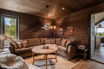 a living room with a couch and a table at Lykka - lovely cabin with amazing view in Torpo