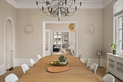 a dining room with a large wooden table and white chairs at NEW Listing! Unique Villa in Bergen in Bergen
