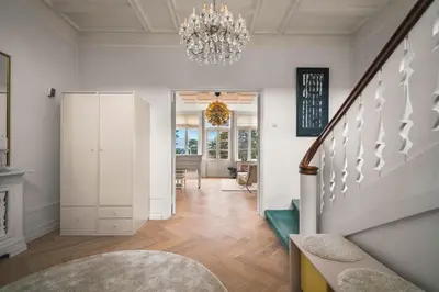 a living room with a staircase and a chandelier at NEW Listing! Unique Villa in Bergen in Bergen