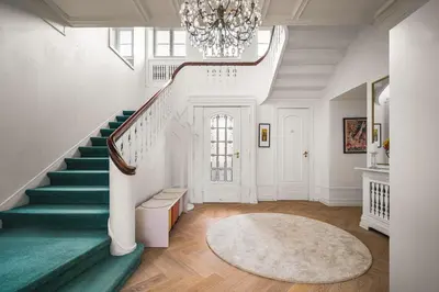 a staircase in a home with a green rug and a chandelier at NEW Listing! Unique Villa in Bergen in Bergen