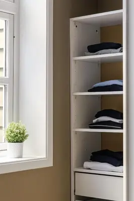 a closet with white shelves next to a window at NEW! I Modern Comfort in the Heart of Bergen in Bergen