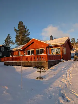 a large wooden house in the snow at Håvi Solsiden 11C in Trysil