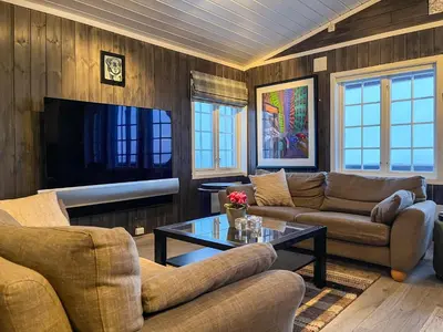 a living room with couches and a coffee table at Bjønabakkens oase in Beitostøl