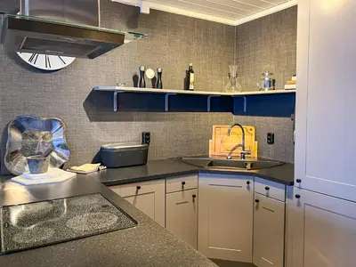 a kitchen with a sink and a counter top at Bjønabakkens oase in Beitostøl