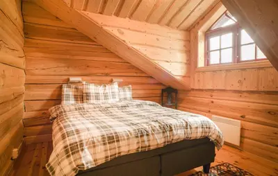 a bedroom in a log cabin with a bed at Awesome Apartment In Bjorli With Wifi in Bjorli