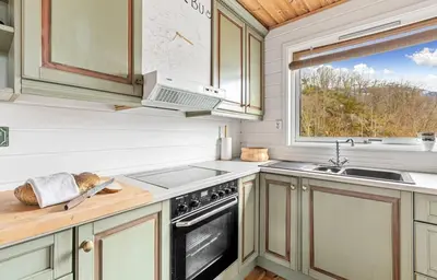 a kitchen with a stove and a sink and a window at Look at this view! 3 BR house overlooking Hardangerfjorden in Kvam