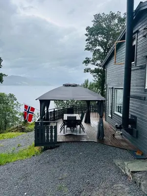a gazebo with a picnic table on a patio at Look at this view! 3 BR house overlooking Hardangerfjorden in Kvam