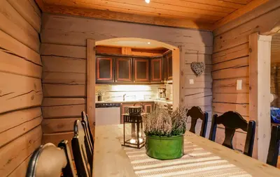 a kitchen and dining room with a table and chairs at 2 Bedroom Gorgeous Apartment In Bjorli in Bjorli