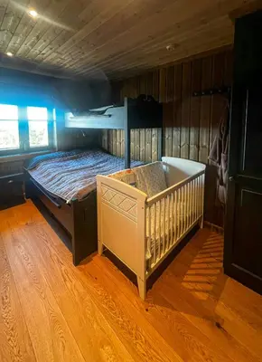 a bedroom with a bunk bed and a crib at Family Cabin With Views Of Jotunheimen in Øyer