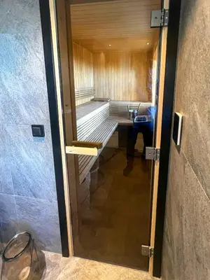 a door to a sauna with a tub in a room at Family Cabin With Views Of Jotunheimen in Øyer