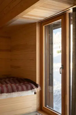a window in a room with a bed next to a door at Architect-Designed Cabin With Ski Trail Near Geilo in Ål