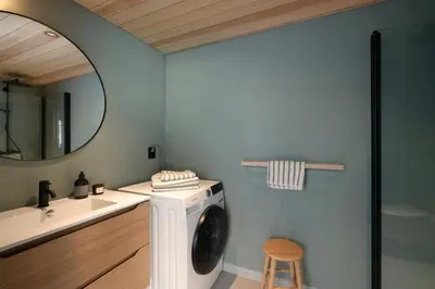 a bathroom with a washing machine and a mirror at Architect-Designed Cabin With Ski Trail Near Geilo in Ål