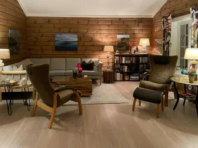 a living room with a couch and chairs and tables at Family-Built Cabin At The Three Line in Eggedal