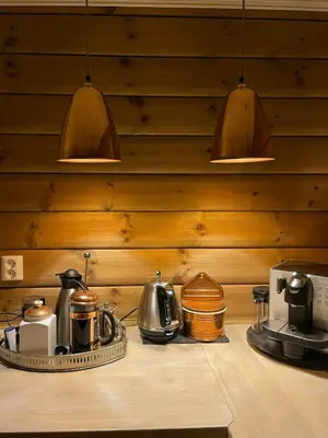a kitchen counter with pots and pans and lights at Family-Built Cabin At The Three Line in Eggedal