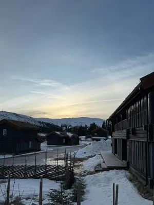 a snow covered village with a building and mountains at Loft Apartment With Ski Access In Trysil in Trysil
