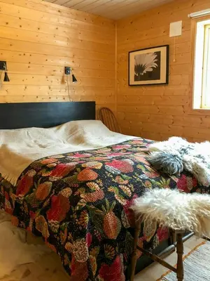 a bedroom with a bed with a quilt on it at Cabin With Sauna By Ski Trails In Skeikampen in Svingvoll