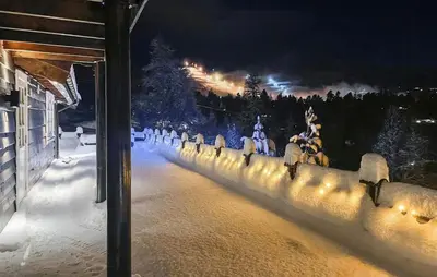a group of people riding horses in the snow at night at Cosy Cabin With Jacuzzi Right By The Ski Slope in Norheimsund