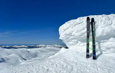 a pair of skis sticking out of a pile of snow at Cosy Cabin With Jacuzzi Right By The Ski Slope in Norheimsund