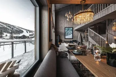 a dining room with a view of the snow at Two-Storey Penthouse By Hemsedal Ski Resort in Hemsedal