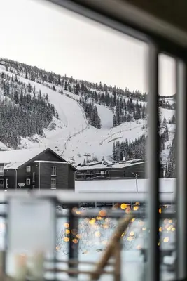 a view of a snow covered mountain from a window at Two-Storey Penthouse By Hemsedal Ski Resort in Hemsedal