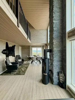 a living room with a wood burning stove in a room at Mountain Cabin With Sauna Atop Fageråsen in Trysil