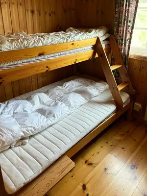 a wooden bunk bed in a wooden room at Mountain Cabin By Femunden Facing Sølen in Nymoen