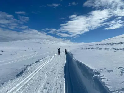 a group of people skiing down a snow covered road at Mountain Cabin By Femunden Facing Sølen in Nymoen