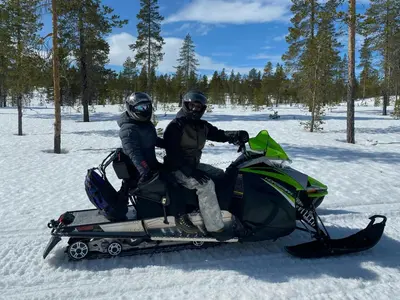 two people sitting on a snowmobile in the snow at Mountain Cabin By Femunden Facing Sølen in Nymoen