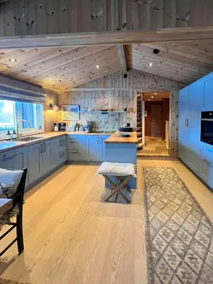a large kitchen with wooden floors and blue cabinets at Wonderful Cottage For Active Families In Hemsedal in Hemsedal