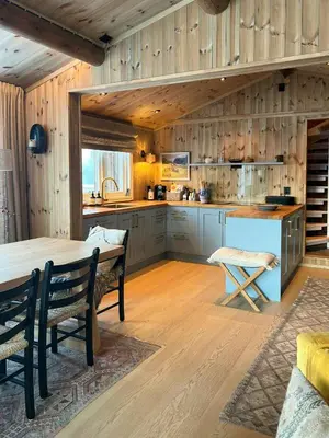 a kitchen with wooden walls and a table and chairs at Wonderful Cottage For Active Families In Hemsedal in Hemsedal