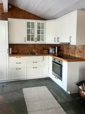 a white kitchen with white cabinets and a sink at Wonderful Cottage For Active Families In Hemsedal in Hemsedal
