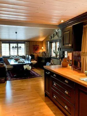 a kitchen with a table and a living room at Modernised Cabin By The Ski Lift In Hovden in Bykle