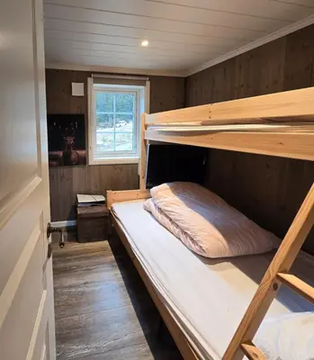 a bedroom with two bunk beds and a window at Mountain Cabin With Ski Access In Høgevarde in Flå