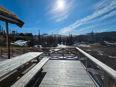 a wooden boardwalk with a view of a mountain at Mountain Cabin With Ski Access In Høgevarde in Flå