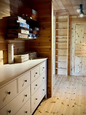 a room with a chest of drawers and books at Unique Cabin And Freestanding Sauna With Views in Aurdal
